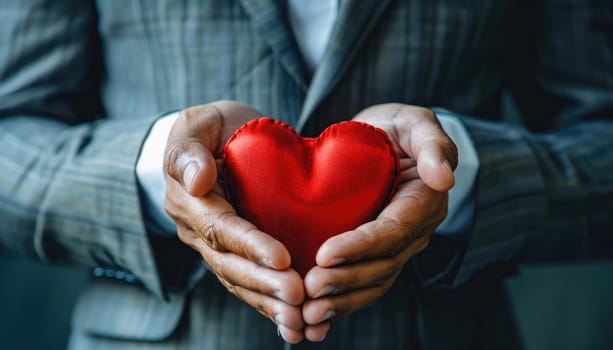 A man is holding a red heart in his hands by AI generated image.