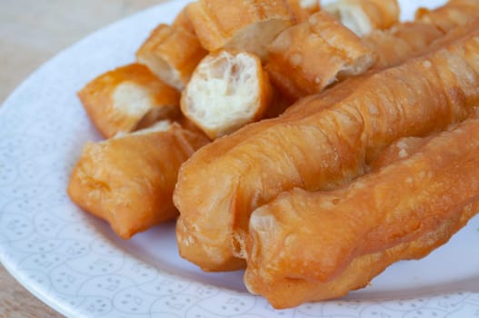 Delicious cakoi or youtiao cake on white plate. Asian food concept.