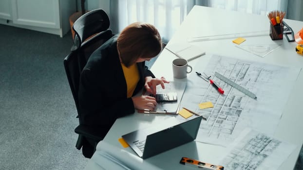 Top view of smart civil engineer drawing and measuring blueprint by using ruler. Aerial view of architect scatch building project plan at meeting table with equipment and safety helmet. Alimentation.