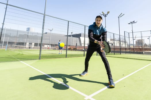 Man playing paddle tennis. Jumping and shooting the ball. High quality photo
