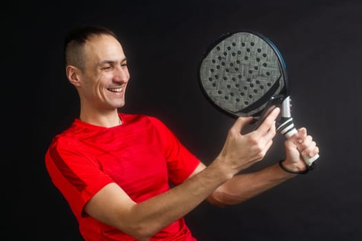man holding paddel racket and smartphone. High quality photo