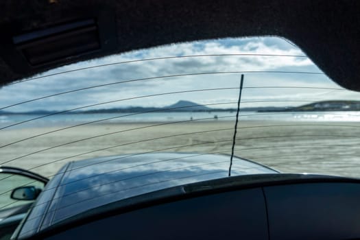 The beach in Downings seen through boot window of car, County Donegal, Ireland.