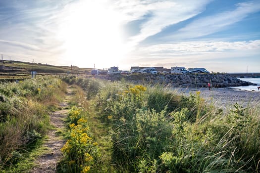 MAGHEROARTY, IRELAND - JULY 31 2022: Holiday makers enjoying the are.