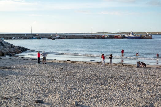 MAGHEROARTY, IRELAND - JULY 31 2022: Holiday makers enjoying the are.