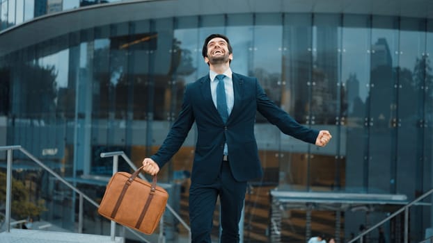 Successful business man celebrate for getting promotion while walking to office. Caucasian receive good news about sales increase or successful project. Manager feel overjoy and happy. Exultant.
