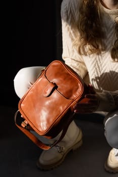 beautiful curly blond hair woman posing squatting with a small brown Model wearing stylish cap white sweater and classic trousers