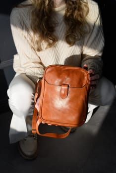 beautiful curly blond hair woman posing squatting with a small brown Model wearing stylish cap white sweater and classic trousers