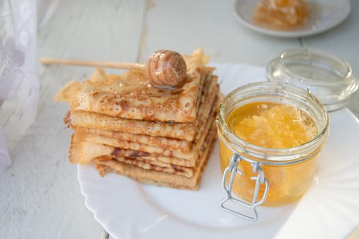 Russian pancakes with honey and a cup of tea from a vintage samovar Maslenitsa festival concept, High quality photo