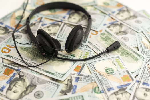 Headphones and American cash money on table. High quality photo