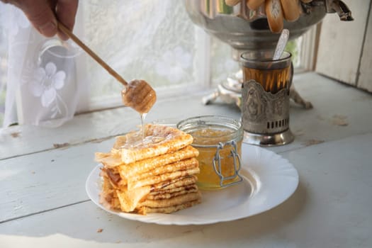 Russian pancakes with honey and a cup of tea from a vintage samovar Maslenitsa festival concept, High quality photo
