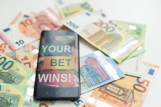 betting on sports, smart phone with working online betting mobile application. High quality photo