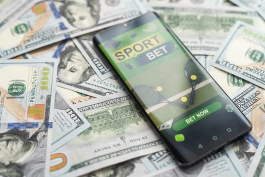 Smartphone with gambling mobile application with money close-up. Sport and betting concept. High quality photo