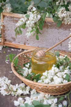 still life with full honeycombs and a jar of ocacia honey on the table, organic enriched beekeeping product for alternative medicine, high quality photo