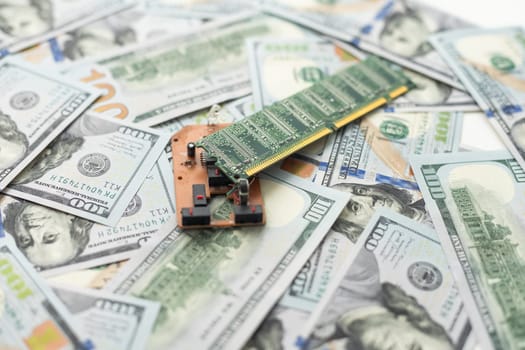 American dollars on the background of a printed circuit board, electronic semiconductor microcircuit. The concept of electronic money, blockchain, cryptocurrency. High quality photo
