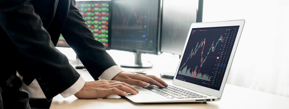 Cropped image of group of expert professional treader discuss about stock market graph show increasing graph while point on the computer display at office. Money exchange, growth chart. Burgeoning.