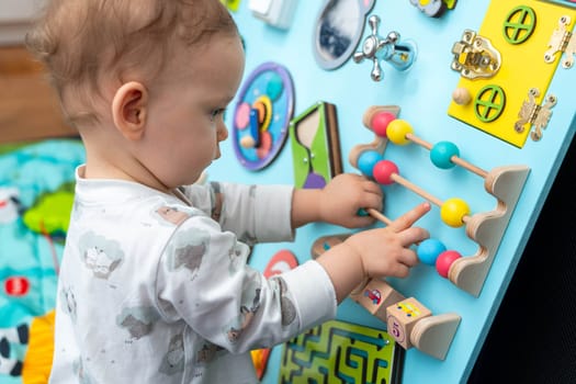 A child studies abacus on a busy board.