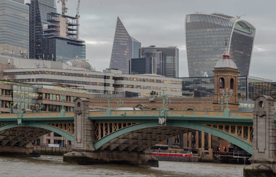 London, UK - Feb 27, 2024 - Beautiful view of Skyscrapers and Southwark bridge in the business district over River thames in city of london. Architectural modern buildings, Copy space, Selective Focus.