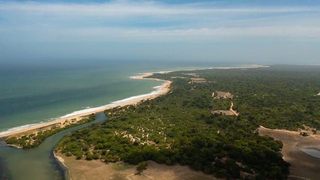 Ocean with a beach in the national park among the jungle.