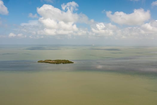 Aerial view of Tropical island and blue sea against the sky and clouds.