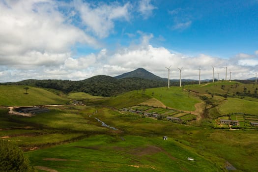 Wind turbines for electric power production on the hills. Wind power plant. Ecological landscape. Ambewela, Sri Lanka.