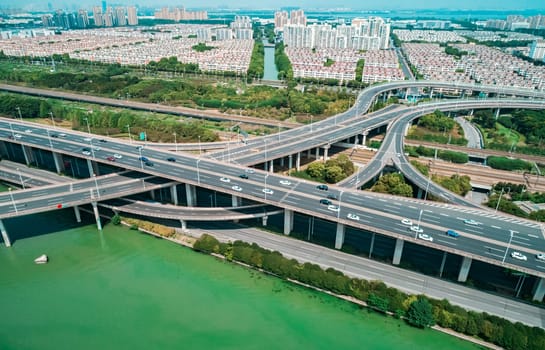 Aerial drone view of highway multi-level junction road with moving cars. China. The concept of the urban.