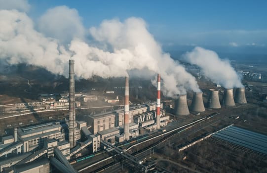 Aerial view of smoking pipes and cooling towers of coal thermal power plant