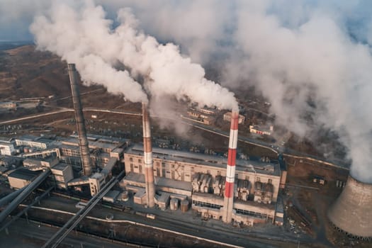 Aerial view of smoking pipes and cooling towers of coal thermal power plant