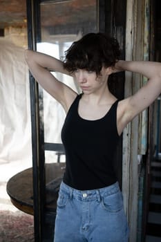 young beautiful woman posing in blue jeans in studio