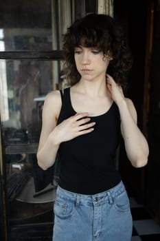 young beautiful woman posing in blue jeans in studio