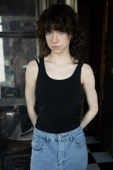 young beautiful woman posing in blue jeans in studio