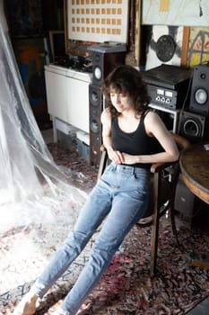 young beautiful woman posing in blue jeans in studio