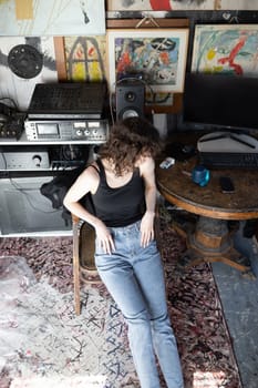 young beautiful woman posing in blue jeans in studio