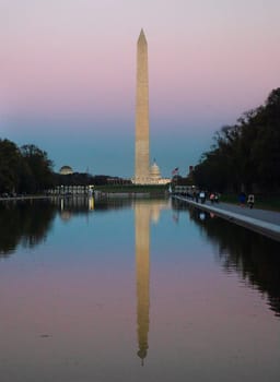 The Washington Monument is reflected in the Reflecting Pool at Washington DC.