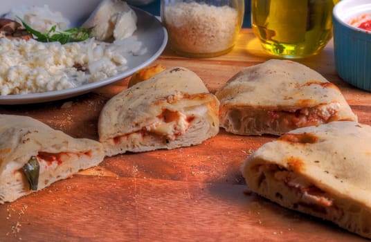 Side view of calzone slices on butcher block surface