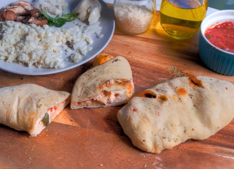 Side view of calzone slices on butcher block surface