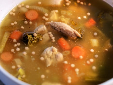Side view of chicken noodle soup 