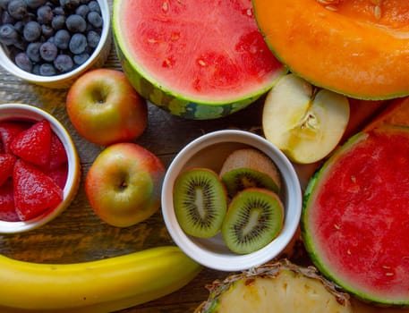 Top View of fresh cut fruit on natural wooden table