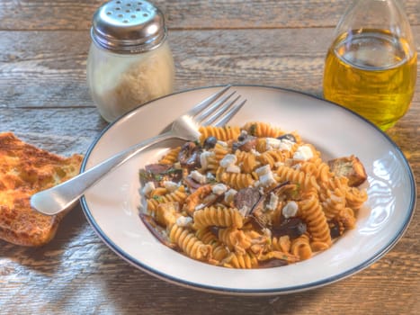 Side view of fusilli with egg plant and goat cheese.