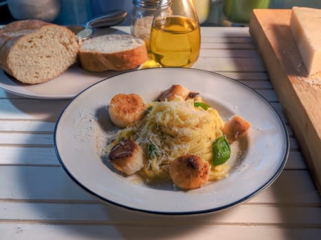 Side view scallops and pasta dish