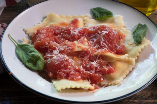 Side view of  Ravioli dinner on natural wood surface