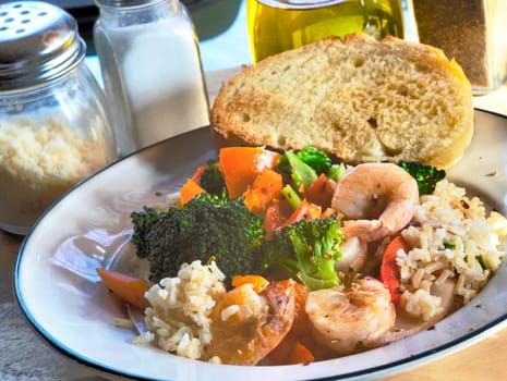 Side view of shrimp and rice with organic vegetables.