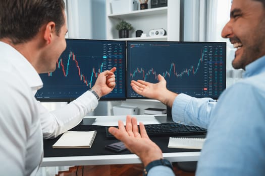 Successful stock exchange traders focusing on high profit chart investment on dynamic database, analyzing on monitor. Concept of discussing financial technology growth at workplace. Sellable.