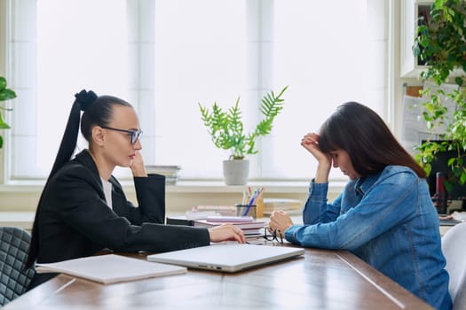 Mental therapy session of sad unhappy depressed stressed mature female with professional psychologist counselor. Talking serious women sitting at table, psychology psychotherapy support help treatment
