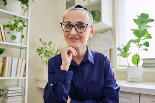 Webcam view of smiling middle-aged woman listening carefully. Female blogger vlogger recording video, business lady during video chat conference call, teacher mentor giving online lesson, filming training course