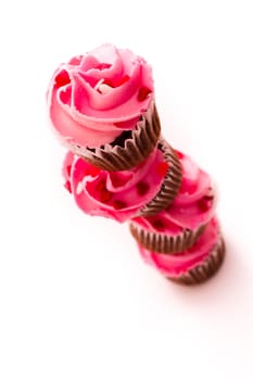 Stack of pink cupcakes on white background.