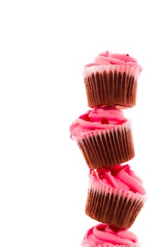 Stack of pink cupcakes on white background.