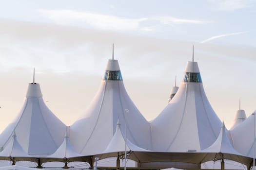 Tents of DIA at sunrise. Denver International Airport well known for peaked roof. Design of roof is reflecting snow-capped mountains.