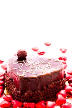 Heart shaped salted caramel cake on white background.