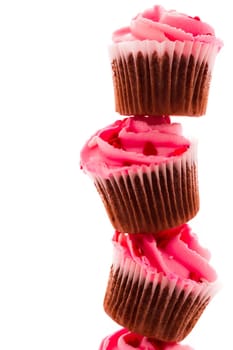 Stack of pink cupcakes on white background.