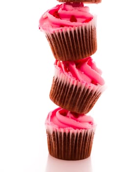 Stack of pink cupcakes on white background.